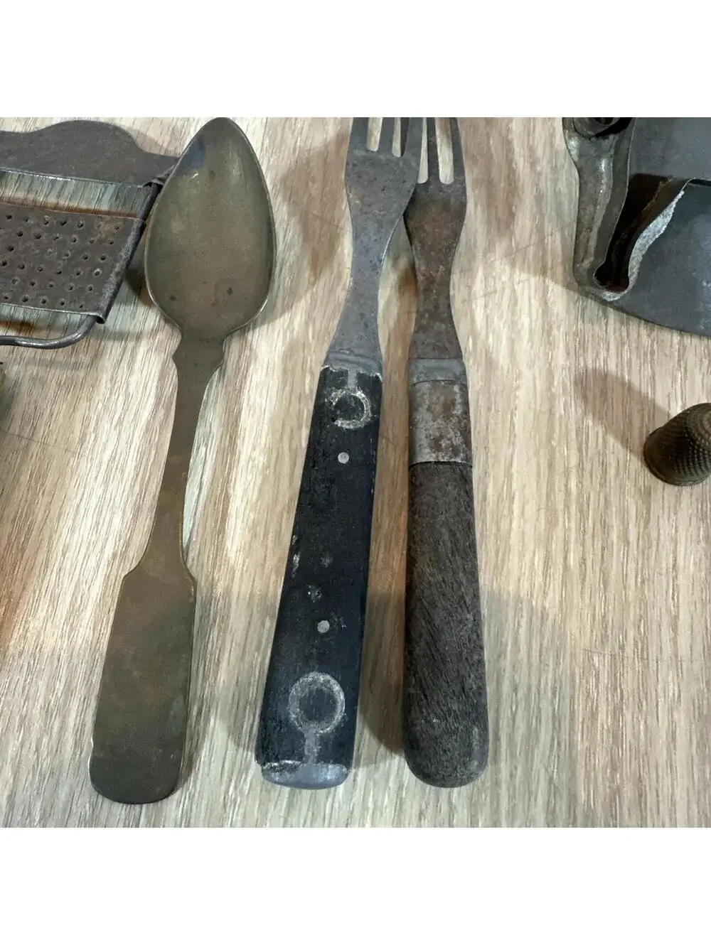 (7) Antique items: 2 graters, 2 forks, 1 spoon,‎ cookie cutter, thimble.